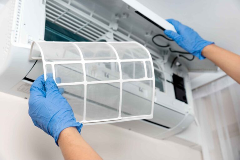 Air conditioning technician performing general servicing to ensure optimal performance and energy efficiency